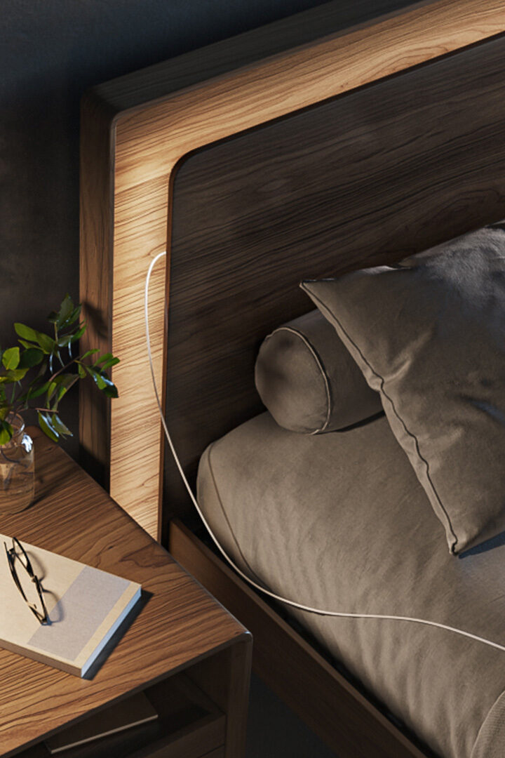 A walnut headboard of a modern bed with built-in lighting that is dimmable.