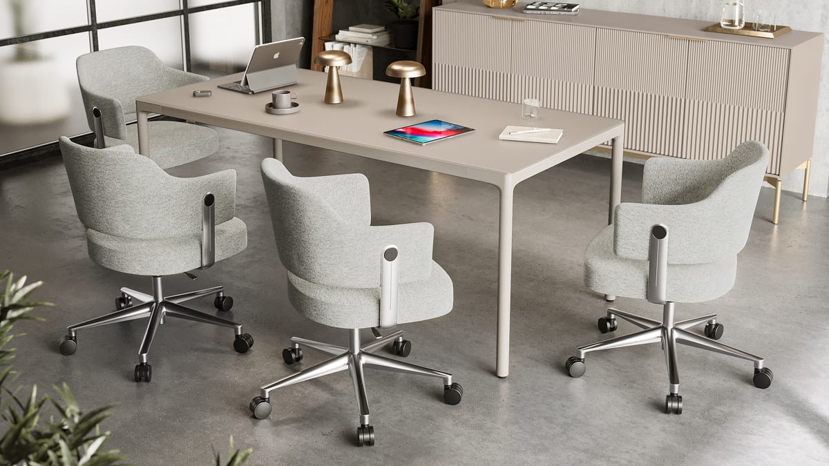 Luma 72x34 work table in Dune shown as a shared workspace for meetings and collaboration.