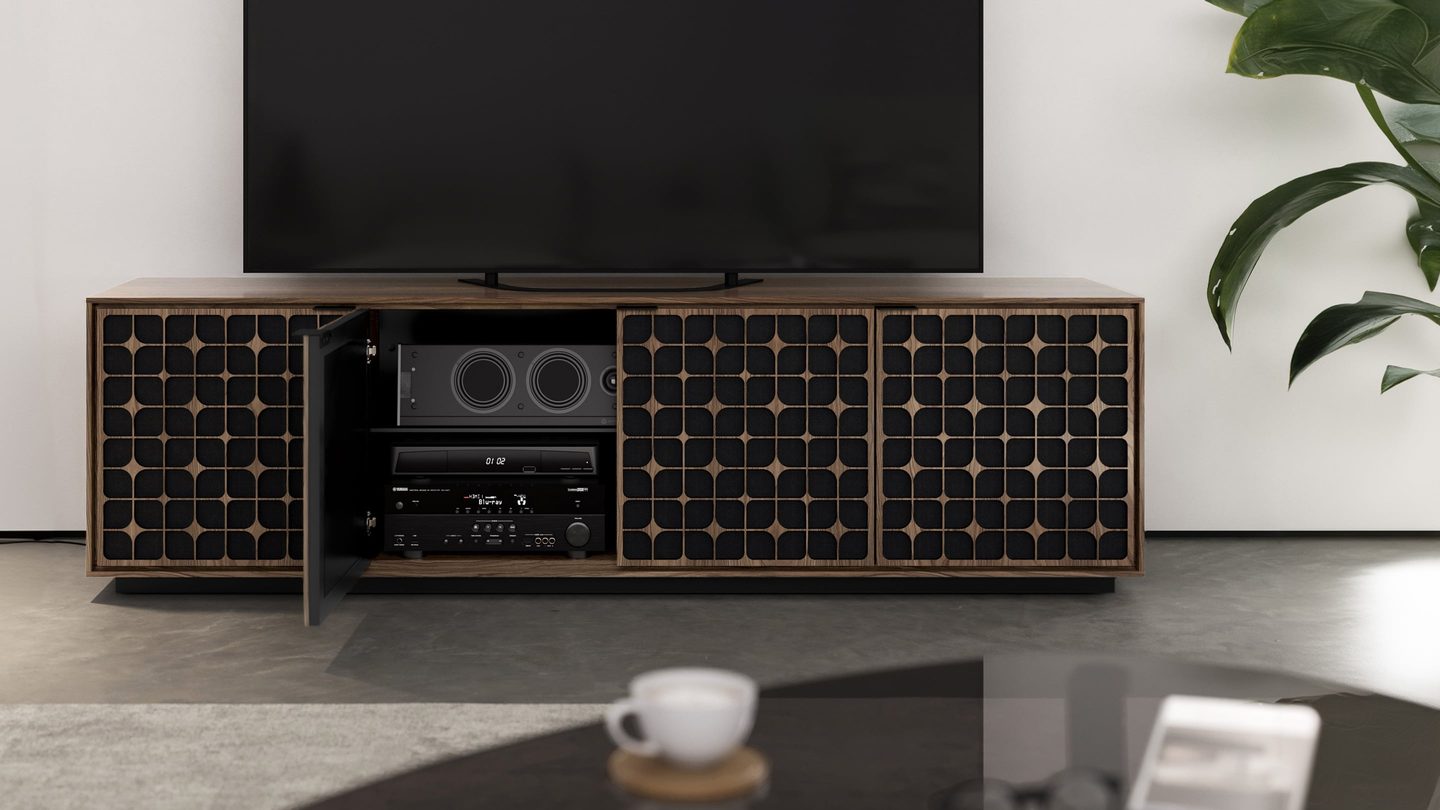 The Elements modern TV stand and storage cabinet by BDI furniture is shown here in a natural walnut finish with the Constellation door pattern. One door is open to reveal internal media storage.