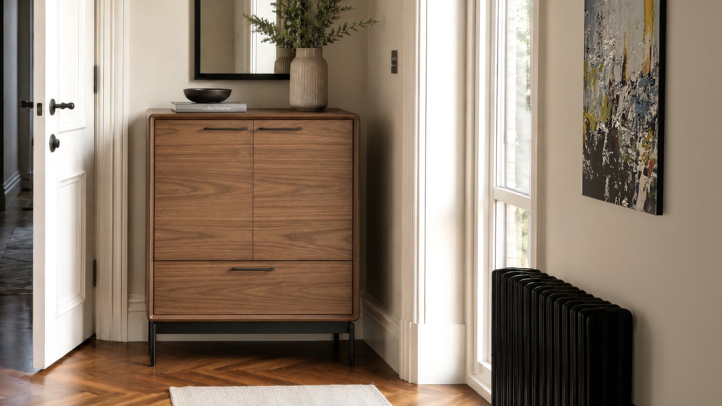 LINQ 7585 walnut entryway cabinet by BDI with concealed storage and a full-width drawer in a modern foyer.