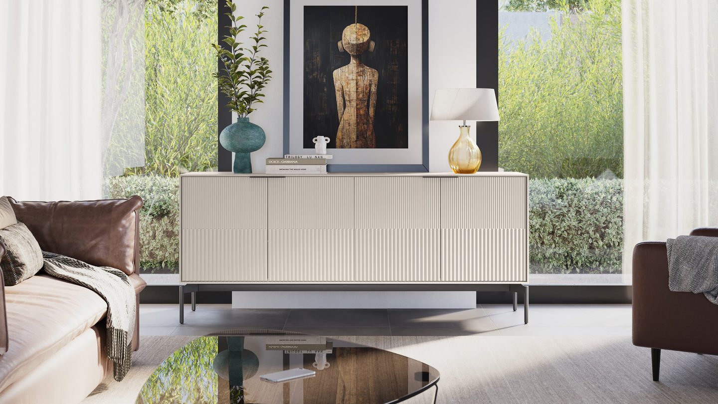 Zig credenza in Dune finish with Brushed Carbon base, styled in a living room with books, a lamp, and artwork above.