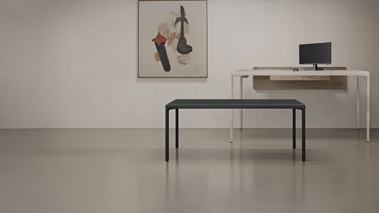 BDI Luma 6763S stationary desk in Black and Luma 6763 Sit+Stand desk in Dune shown side by side.