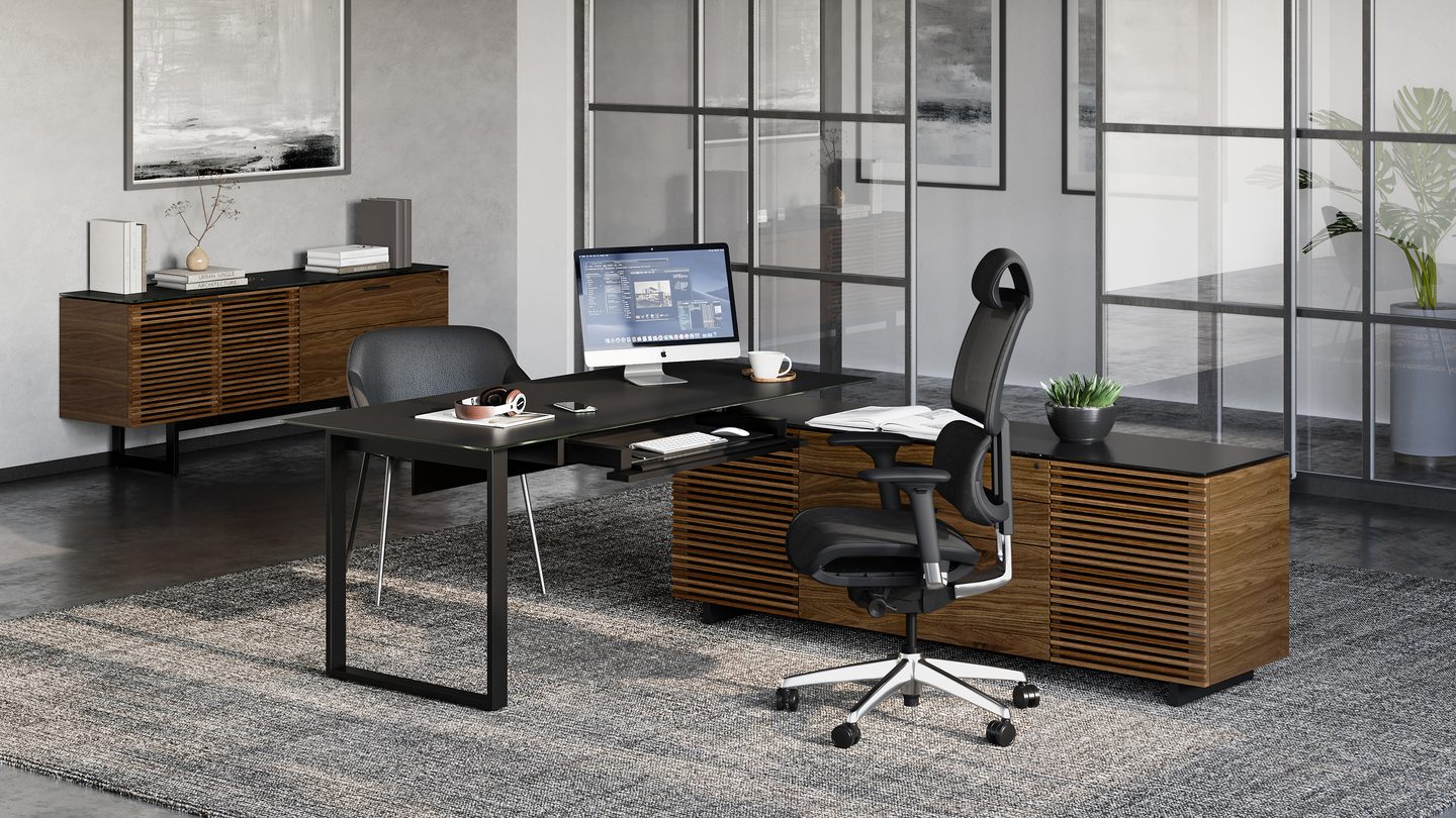 BDI Corridor L-shaped desk paired with a matching natural walnut storage credenza, showcasing louvered detailing in a warm, contemporary workspace.