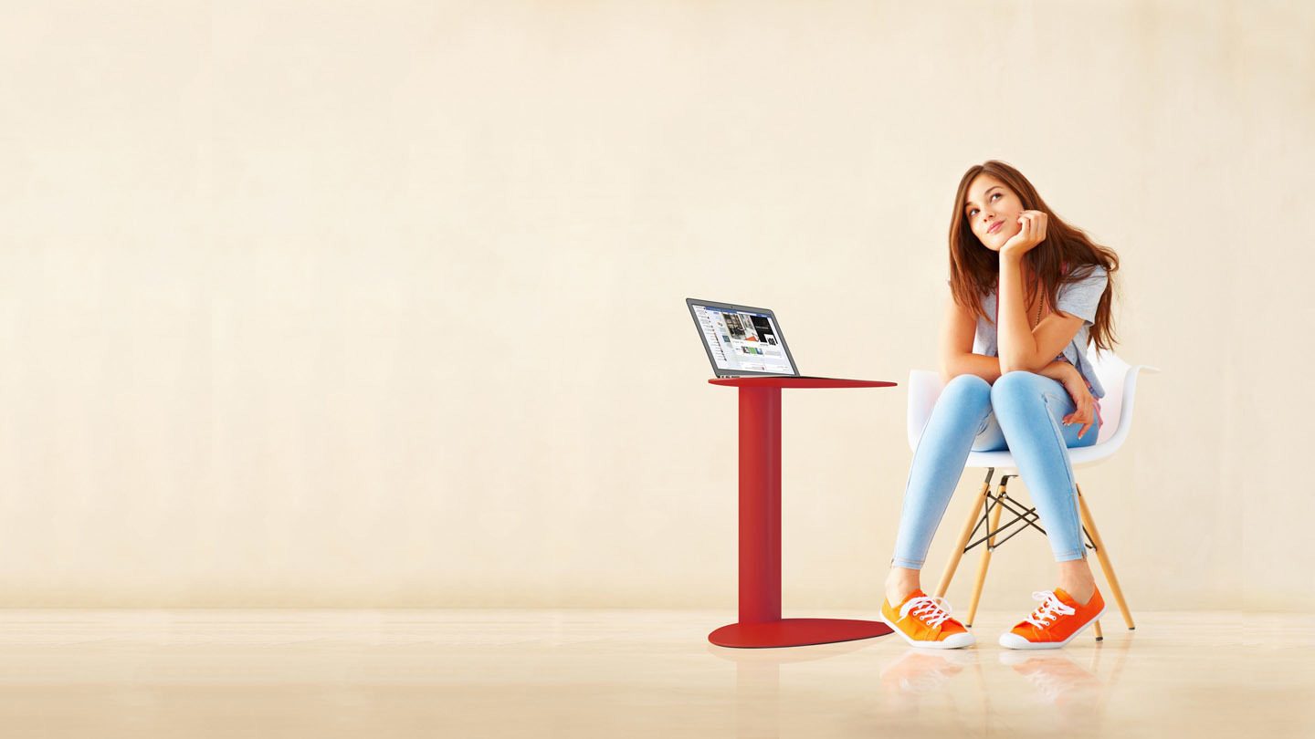 Student attending class from home, using a laptop table and computer.