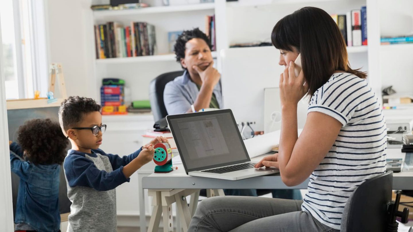 Parents working from home together with children.
