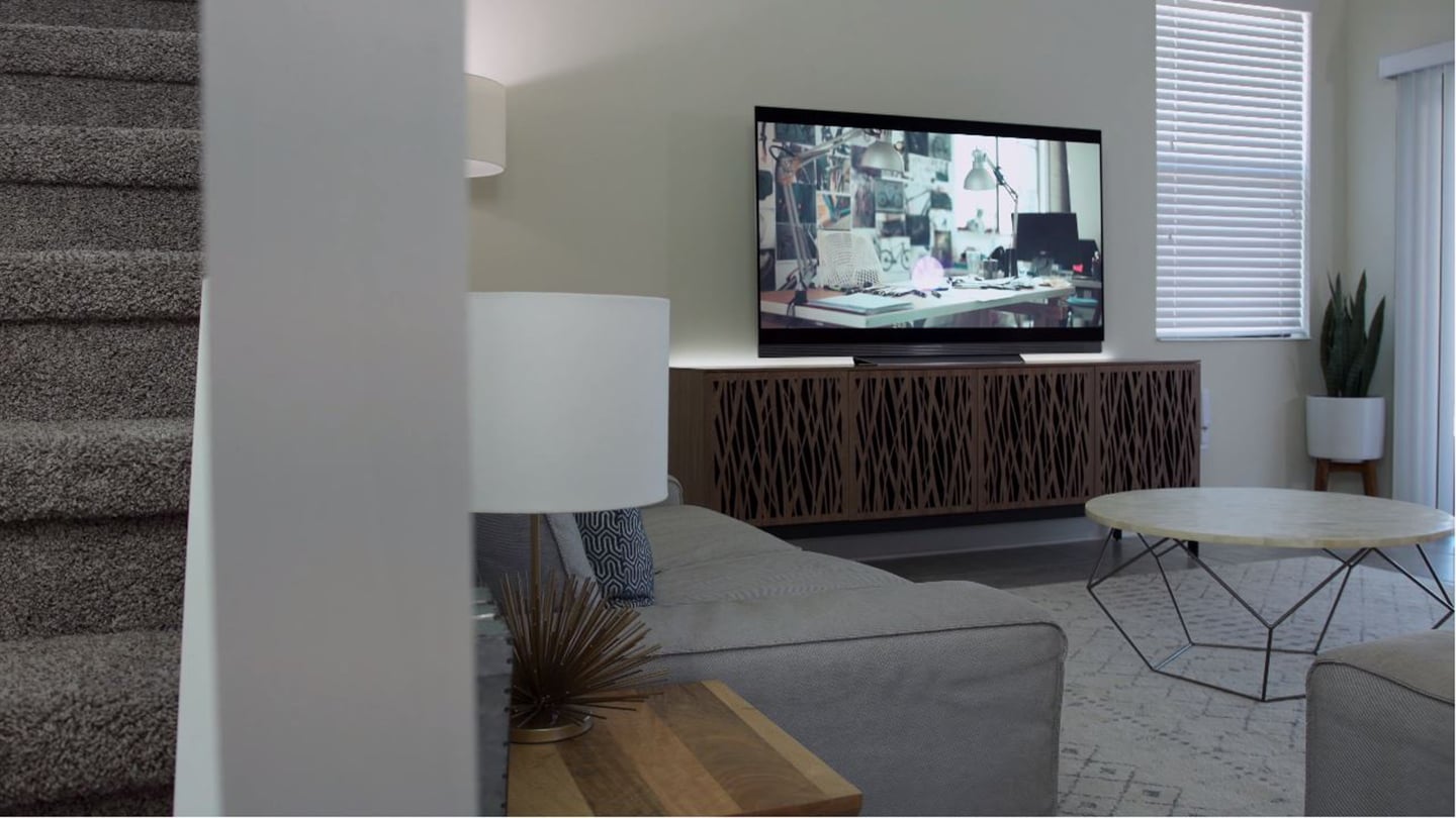 BDI Elements 8779 media cabinet in natural walnut, displaying a 4K television in a living room.