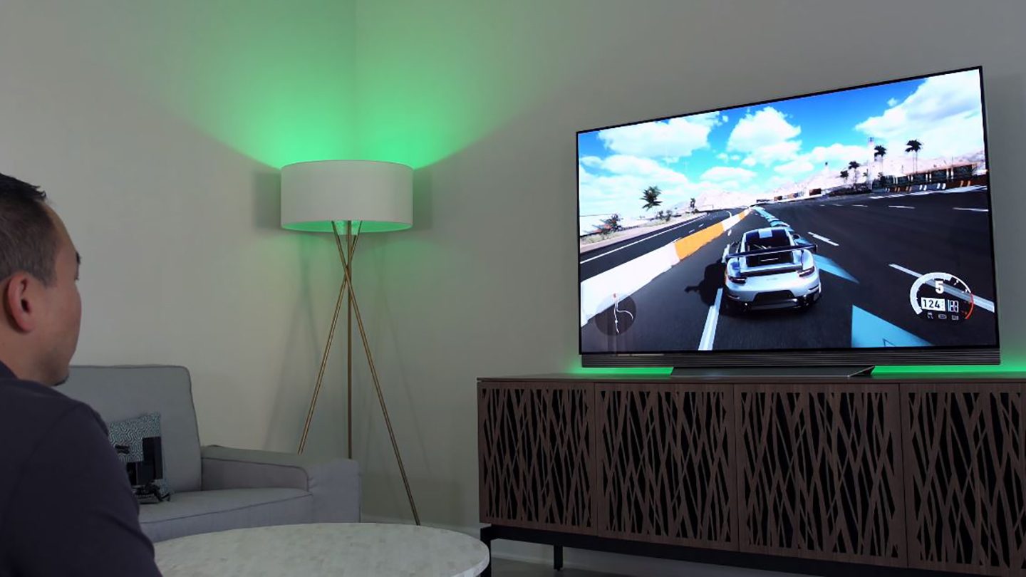 Danny Winget playing Forza Horizon 5 atop a BDI Elements modern TV stand.