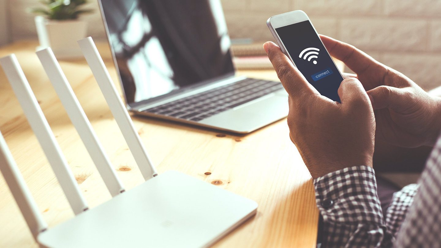 Man checking WiFi signal strength and download speeds on his mobile device.