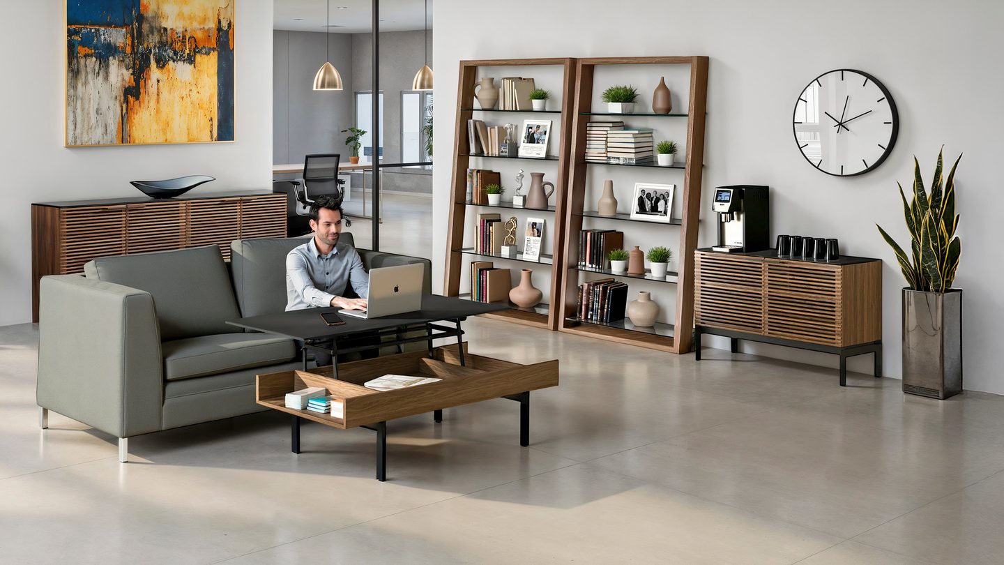 A young man is sitting on a couch, surrounded by multiple BDI designs, showcasing the versatility offered by BDI to create modern and functional spaces in the home.