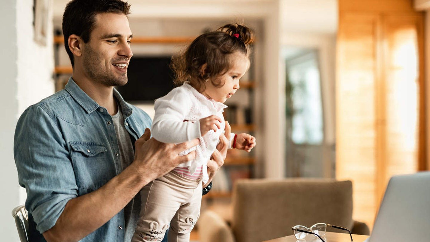 Father, working from home, and playing with his daughter.