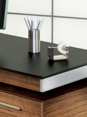 Modern desk from BDI with satin-etched black glass top surface