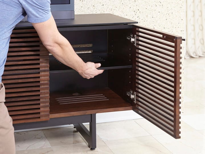 Adjustable shelves inside the cabinet allow you to make space for all the components you need for a full theater experience.