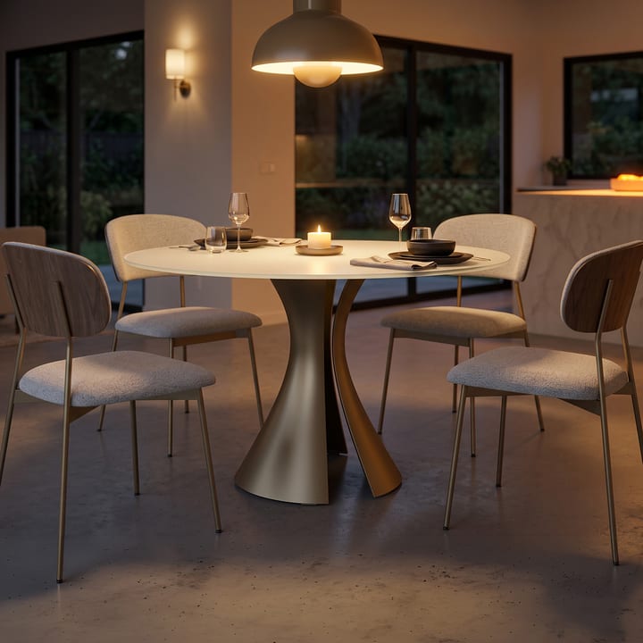 BDI Bloom 7722 60-inch round dining table with Oyster glass top and Bronze sculptural steel base in a modern dining setting.