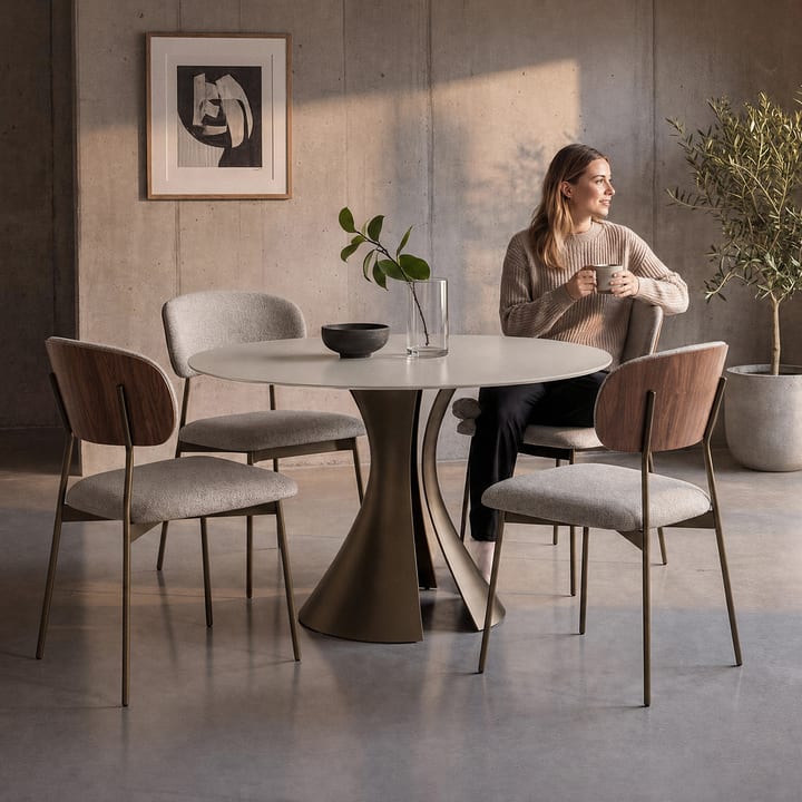 BDI Bloom 7720 48-inch round dining table with Oyster glass top and Bronze sculptural steel base in a modern dining setting.