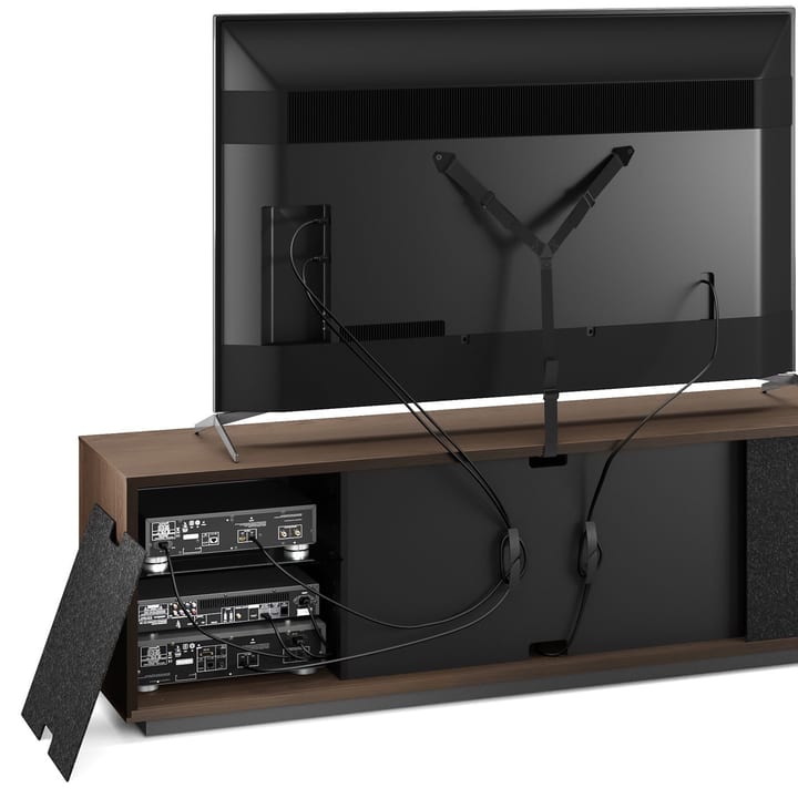 The view of the back of an Elements modern TV and storage cabinet by BDI Furniture reveals convenient rear access panels, built-in cable management, and a TV safety strap.
