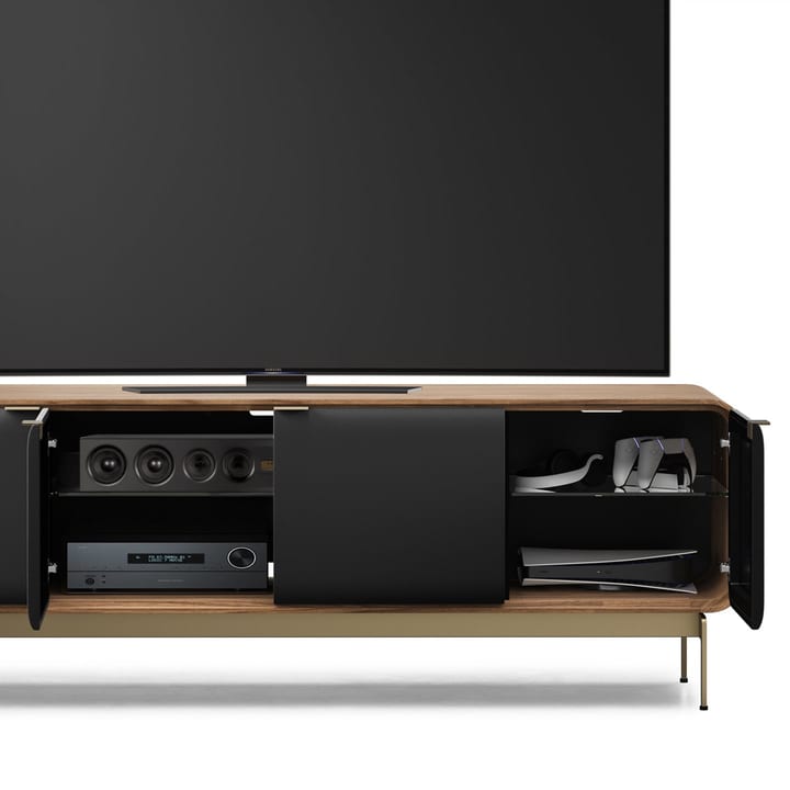 BDI Plume 8079 four-door media cabinet in Natural Walnut, with open doors revealing speakers, a receiver, a PlayStation gaming console, and media storage.