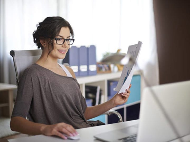 Attractive millennial woman working from home.
