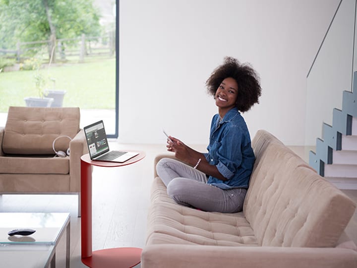 Bink laptop desk in Cayenne finish being used by a young millennial at home.
