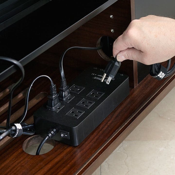 BDI media cabinets feature a host of cable management features, including concealed space for a power strip to connect all of your devices in one place.