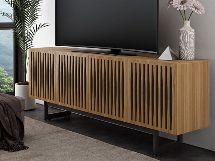 The Elements media cabinet and TV stand by BDI Furniture features acoustically transparent doors that allows for sound pass-through behind closed doors.