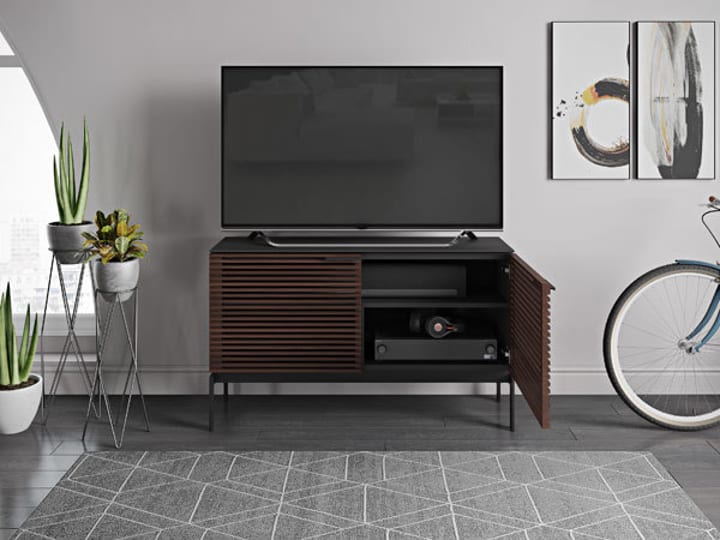 Corridor 7128 SV slim modern TV stand by BDI furniture in Chocolate Stained Walnut, shown with one door open, revealing internal storage and a soundbar shelf.
