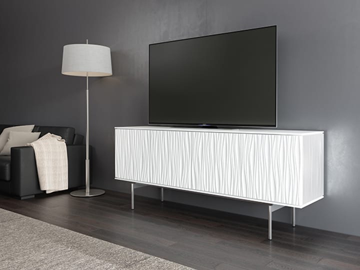 The Tanami modern credenza and AV cabinet in Satin White finish, floating atop polished chrome legs.
