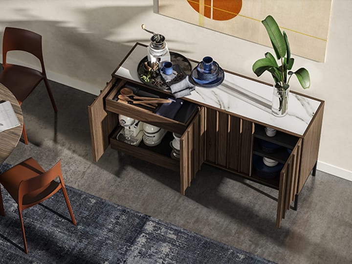 Cosmo storage console, sideboard, and buffet. Doors are open to reveal storage of kitchen appliances, silverware, dishes, and serving platters.